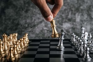 hand of a man playing chess, comparison among men