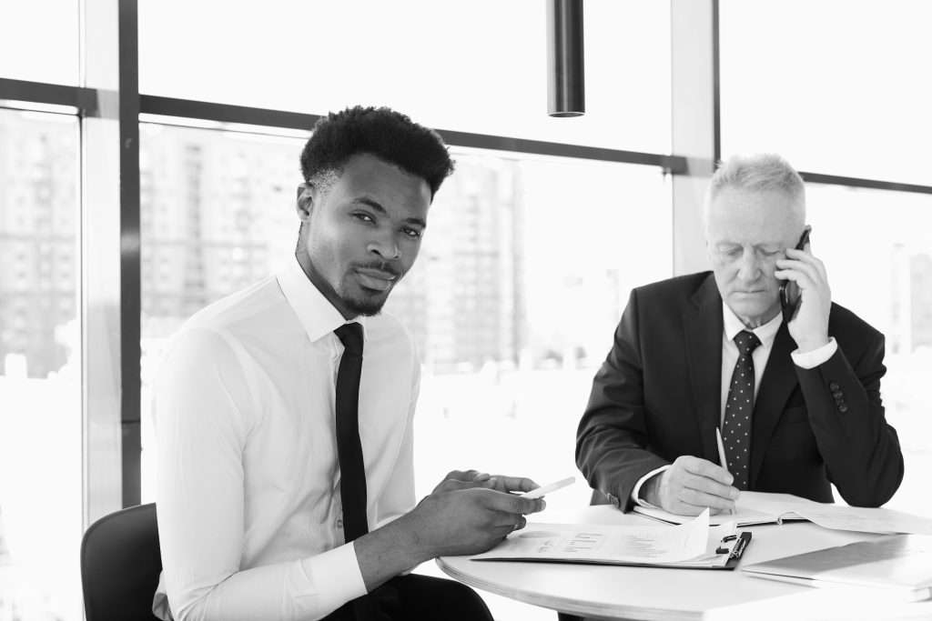 2 business men at desk, faith in the workplace concept