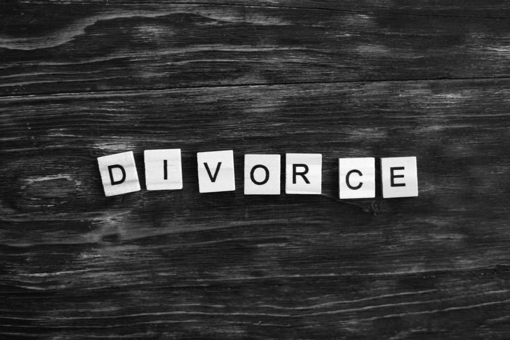 inscription of the word "divorce" made with tiles on a wooden table