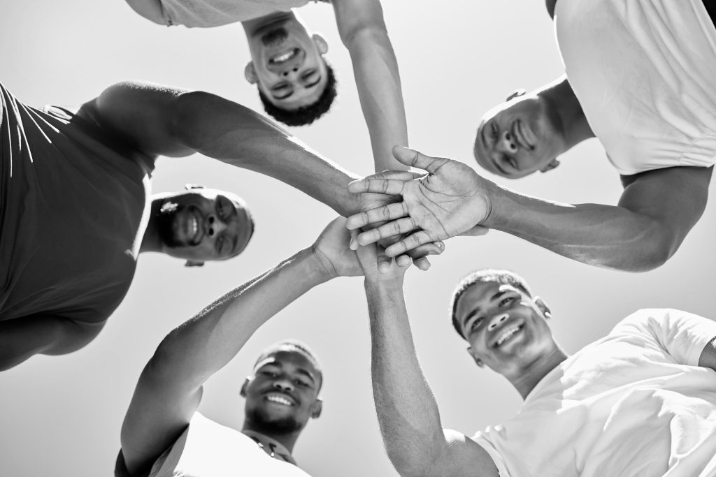 group of diverse guys with hands in - Discover key Bible verses that reveal the vital role of community in spiritual life, offering guidance for fostering strong, supportive bonds - supportive community concept